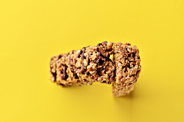 Banner bar granola stand upright on a yellow background in the center view from above with a copy space. High quality photo