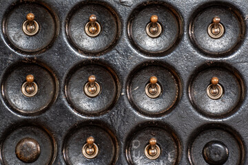 close up of a bank of vintage light switches