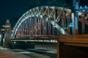 Obraz premium the beautiful metal bridge of Peter the Great across the Neva River in St. Petersburg against the night sky