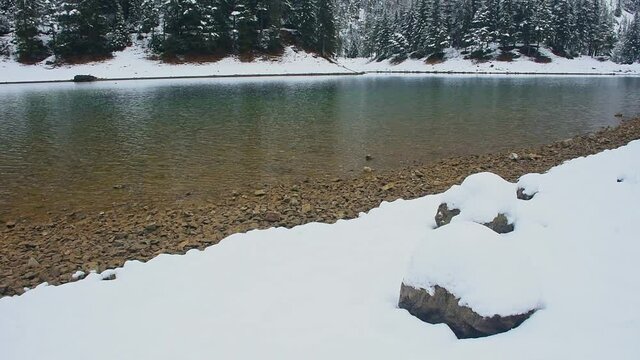 Amazing winter landscape with snowy mountains and clear waters of Green lake (Gruner see), famous tourist destination in Styria region, Austria