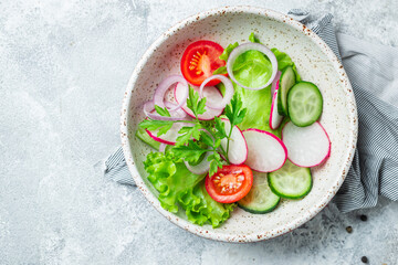 healthy fresh salad vegetables tomato, cucumber, radish mix lettuce portion on the table healthy meal snack copy space for text food background rustic image keto or paleo diet vegan or vegetarian food