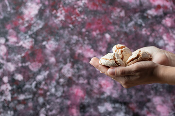 Holding crispy butter cookies in the hand
