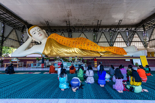 Pilgrims praying before a reclining Buddha, Su Taung Pyi pagoda, Myitkyina, Kachin state