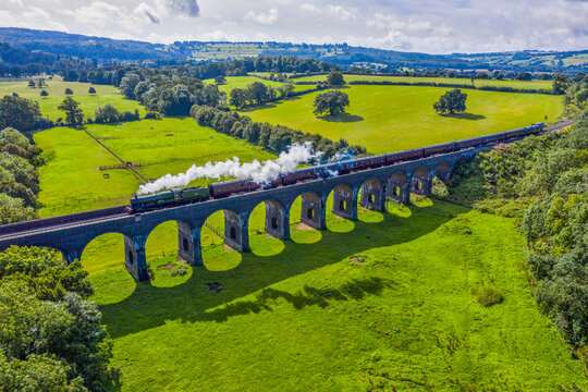 Steam locomotive crossing the Stanway Viaduct, Toddington, Gloucestershire