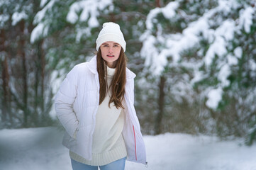 Fototapeta na wymiar beautiful smiling young woman in wintertime outdoor. Winter concept