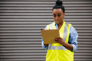Warehouse owner checking off inventory list
