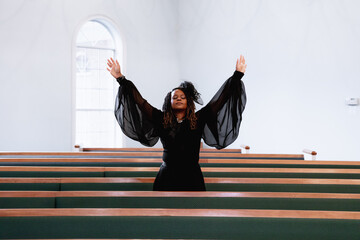 Black woman giving praise and worship to heavenly Father on Easter Sunday
