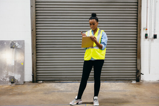 Warehouse owner checking off inventory list