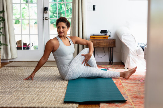 African American woman doing palates core strength training at home