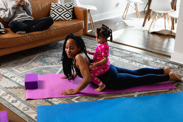 Mother and daughter working out at home doing exercises