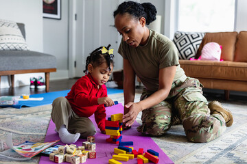 Mother and daughter playing games in living room