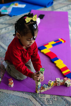 Young black girl playing with blocks