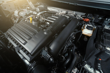 Modern turbocharged eco-friendly engine or motor under vehicle hood close up.