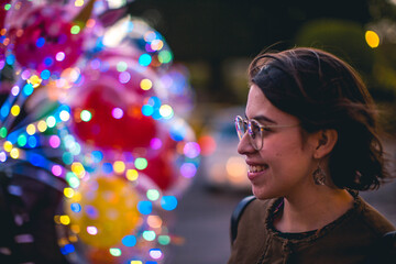 happy young woman with balloon behind her