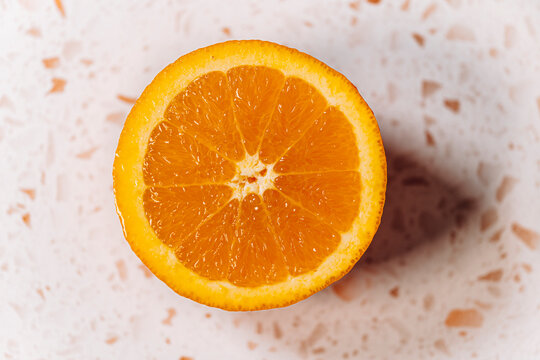 Half orange close-up on a modern terrazzo marble
