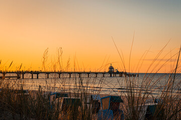 Sonnenuntergang in den Dünen mit Blick auf die Seebrücke Zinnowitz auf Usedom