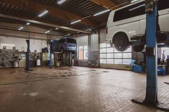 in car workshop there are lifting platforms for repairing cars