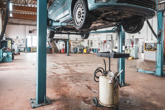 in car workshop there are lifting platforms for repairing cars