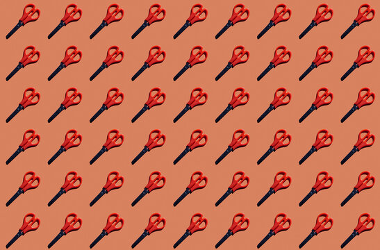 Pattern of rows of scissors against red background