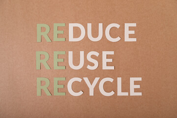 Reduce Reuse Recycle letters on a craft paper