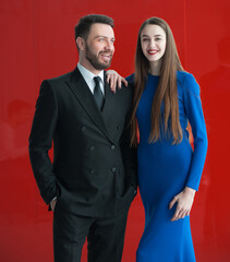 Successful man and woman businesspeople on red background