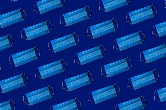 Pattern of protective face masks against blue background
