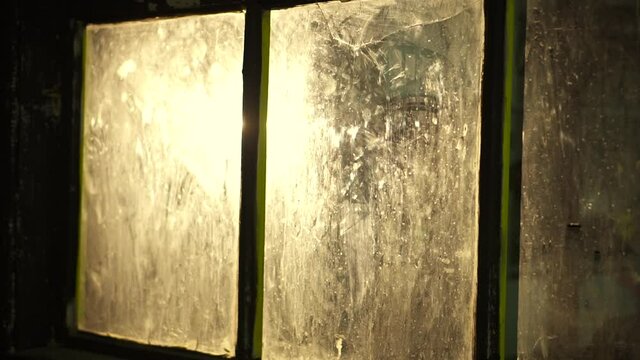 Dirty glass in a dark room. Glass with a crack in the basement with reflection. High quality FullHD footage