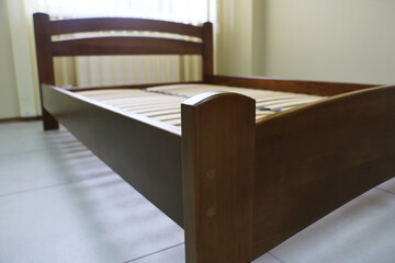 arched wooden bed with slats