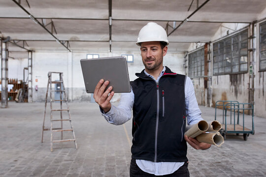 Male real estate developer using digital tablet while working in building
