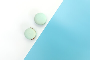 Tasty blue french macarons or macaroons on a white and blue background. Place for text. color geometry