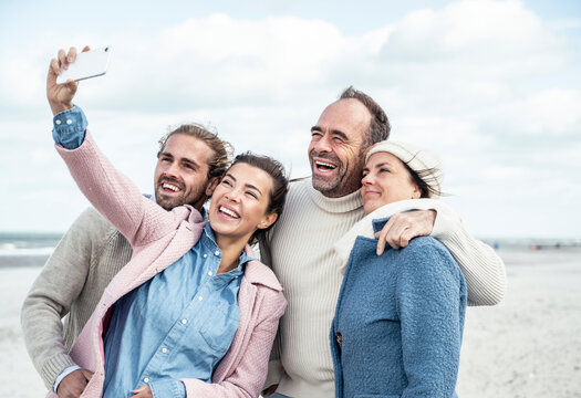 Group of friends taking selfie at beach