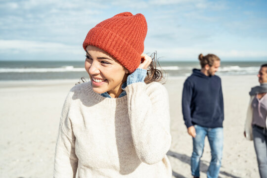 Portrait of woman knit hat standing on beach