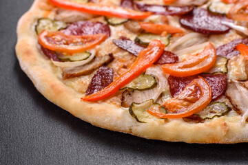Fresh delicious pizza made in a hearth oven with sausage, pepper and tomatoes