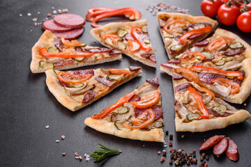 Fresh delicious pizza made in a hearth oven with sausage, pepper and tomatoes