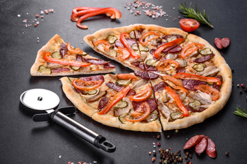Fresh delicious pizza made in a hearth oven with sausage, pepper and tomatoes