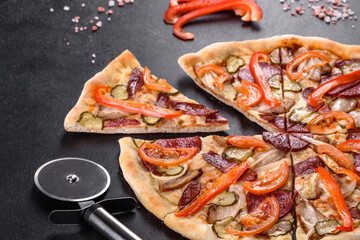 Fresh delicious pizza made in a hearth oven with sausage, pepper and tomatoes