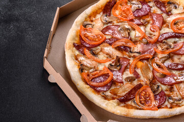 Fresh delicious pizza made in a hearth oven with sausage, pepper and tomatoes