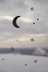 Close up picture of drawing moon and stars on the window, as illustration concept. Abstract wallpaper with night sky in day time. Dreaming picture with graphic design on the window 