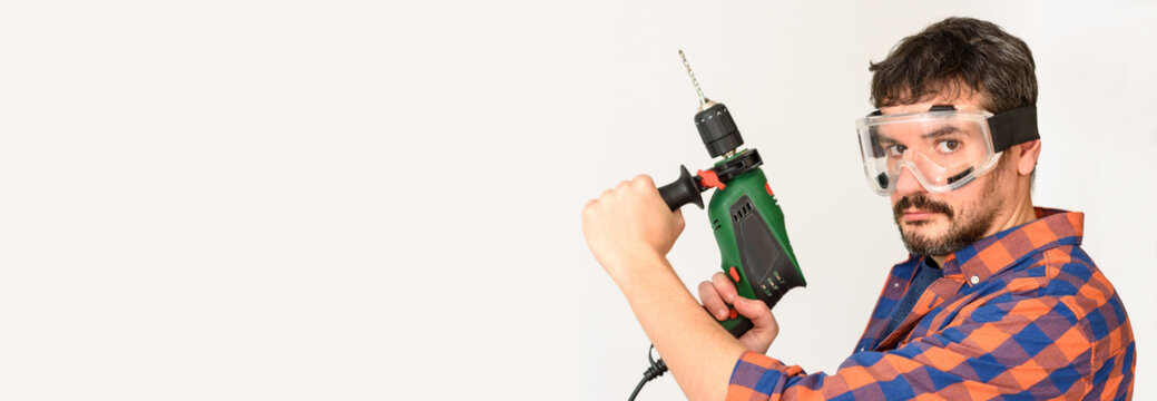 DIY Enthusiast Man Holds A Drill