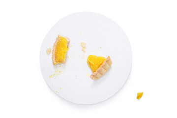 Eaten bit of french lemon tart, top viewTraditional french lemon tart, with orange slice