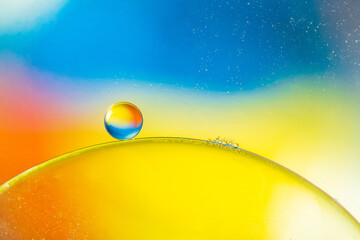 Closeup of abstract background with round shaped cells of vaccine of different sizes illuminated by colorful light
