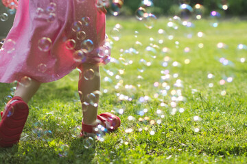 Little Girl Running Through Soap Bubbles