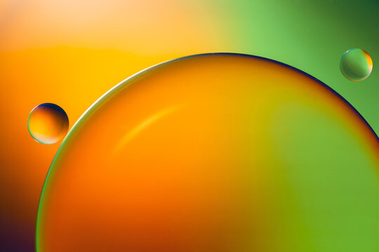 Closeup of abstract background with round shaped cells of vaccine of different sizes illuminated by colorful light