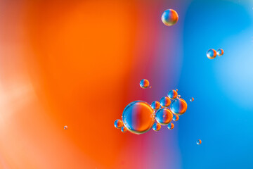 Closeup of abstract background with round shaped cells of vaccine of different sizes illuminated by colorful light