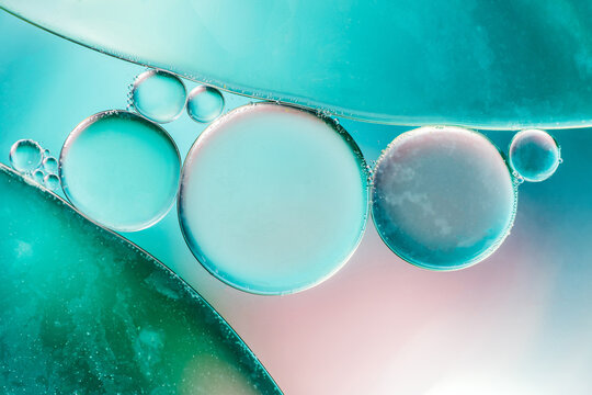 Closeup of abstract background with round shaped cells of vaccine of different sizes illuminated by colorful light