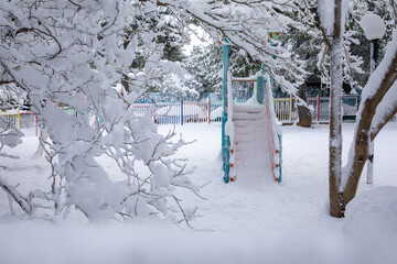 Winter morning snow covered playground in the Athens city, Greece, 16th of February 2021.
