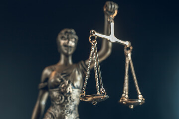 detail of lady justice statue isolated on dark background
