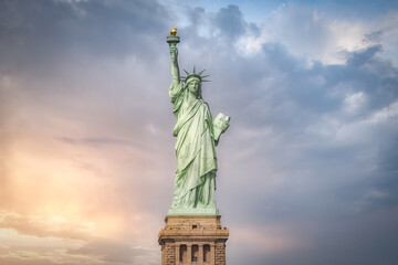 Statue of Liberty located on Liberty Island in New York against blue cloudy sky