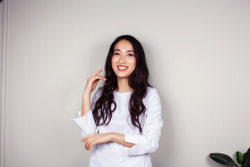 young asian woman doctor in white uniform gesturing positive on gray background, lifestyle healthcare people concept