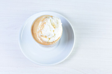 
Coffee and chocolate milkshakes, with chantilly cream on white wooden background